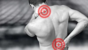 Man in black and white experiences neck and back pain illustrated with red circles