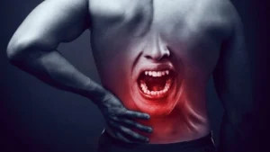 Gray illustration of a man and a red face inside his lower back experessing pain