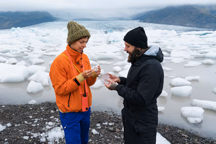 Couple wearing winter clothes in icy climate outdoors talk to each other