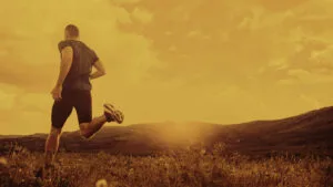 Man running with mountains in background
