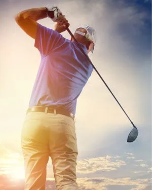 Man wearing white cap swings baseball club