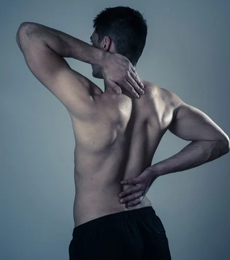 Shirtless man experiences neck and back pain