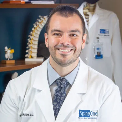 SpineOne doctor Bradley Hakim smiles