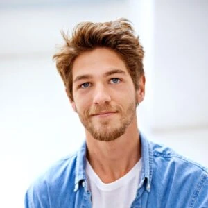 Provider wearing white lab coat points to 3D spine model