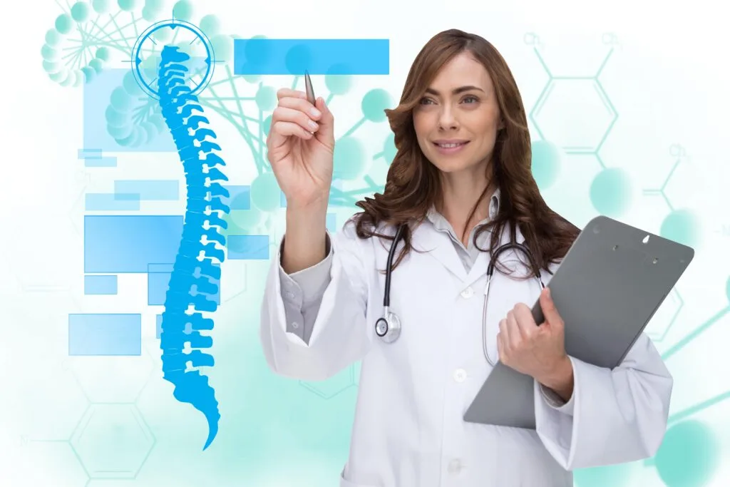 Female doctor wearing white lab coat points with pen beside spine graphic