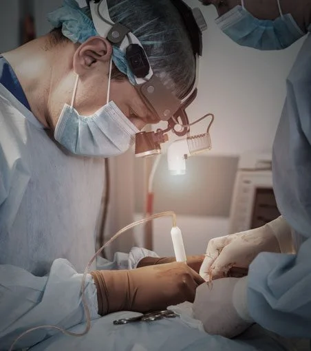 Doctors wearing scrubs perform treatment on a patient