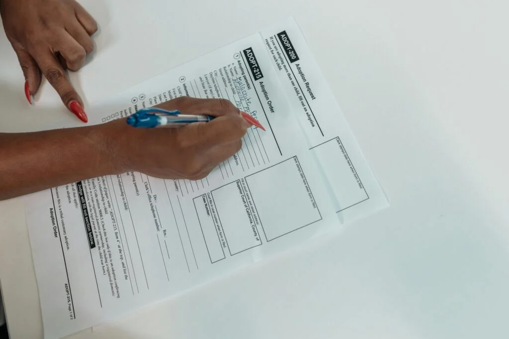 Person fills out adoption paperwork