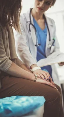 Provider talks with female patient at clinic
